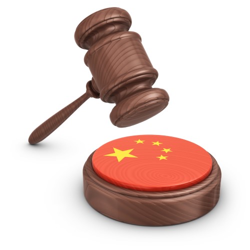 An image of a gavel pounding on a Chinese flag. 