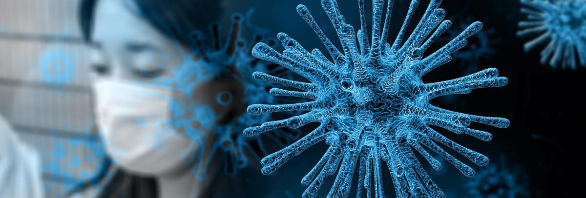 An image representing the Coronavirus outbreak. In the foreground, a spiky germ shape is rendered in black and neon blue. In the background, there is an out-of-focus woman with black hair wearing a face mask.