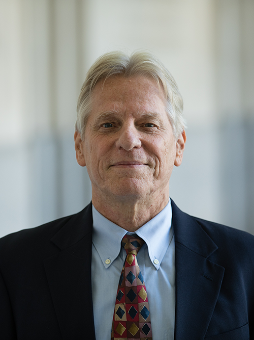 A photograph of a white man in a suit.