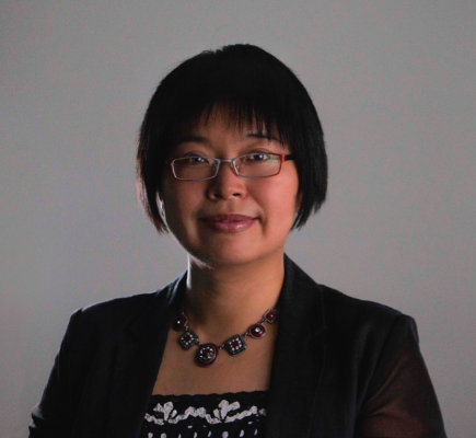 A photograph of an Asian woman with bobbed hair. 